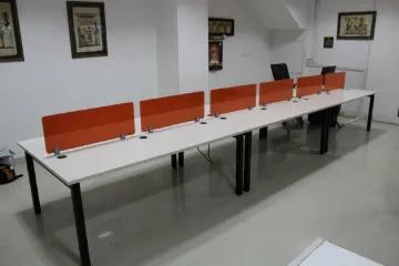 Linear bench workstation with orange partition panels