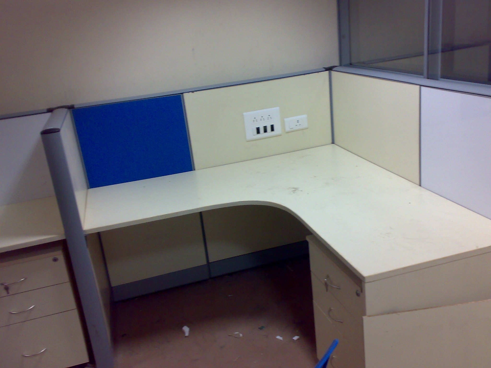 Bench workstations with blue chairs and privacy panels