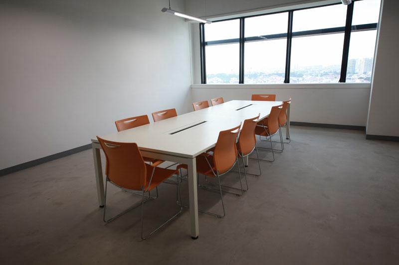 Conference table installation with orange seating