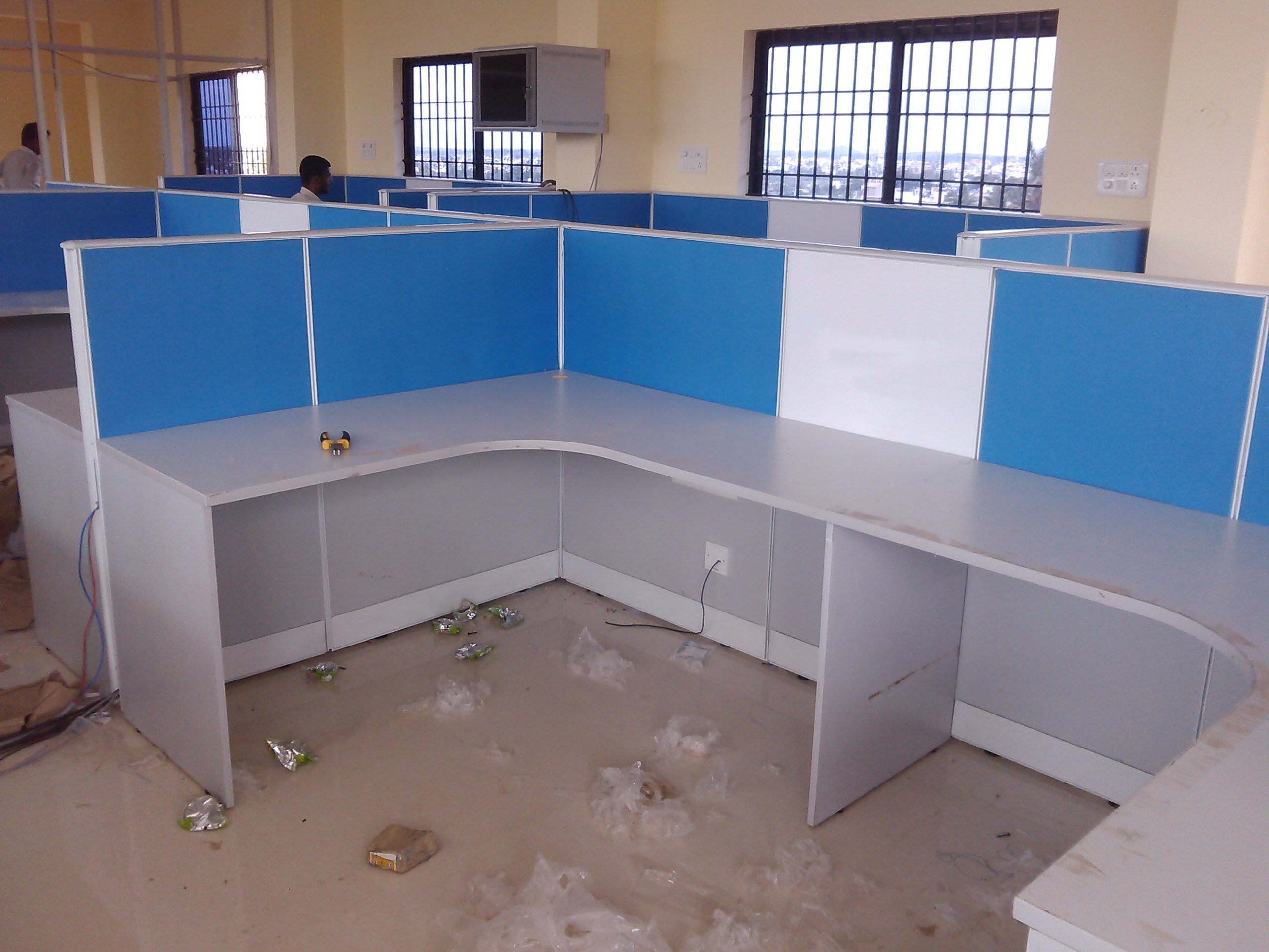 L-shape workstation installation with blue panels